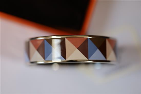 A Hermes, Paris enamelled bangle with geometric pattern, with pouch and box.